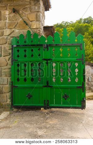 Old Rustic Wood Gate Painted In Green With Masive Metal Hinges