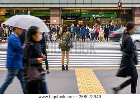 Tokyo, Japan - October 2017 : Undefined Japanese People Crowd Are Waiting To Crosses The Street Betw