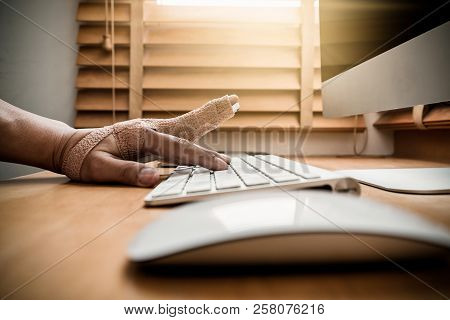Closeup Hand With Weir Wrist To Working With Computer Keyboard With Mouse On The Wooden Table, Hardw