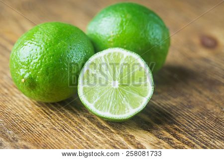 Fruit Lime With Lime Slices Over Wooden Background. Citrus Fruit.