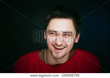Emotional Young Man Photo In Studio On Blue Background.