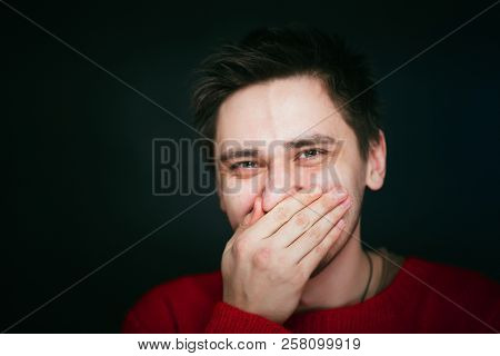 Emotional Young Man Photo In Studio On Blue Background.