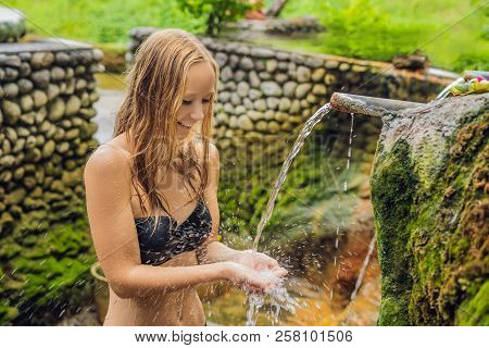 Young Woman Tourist In Belulang Hot Springs In Bali On The Background Of Rice Terraces
