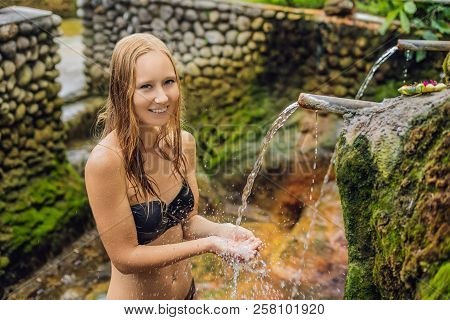 Young Woman Tourist In Belulang Hot Springs In Bali On The Background Of Rice Terraces