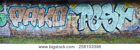 Full And Acomplished Graffiti Artwork. The Old Wall Decorated With Paint Stains In The Style Of Stre