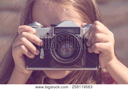 The Girl Photographs An Old Soviet Camera In Brown Tonting.