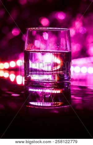 Colored Lighting Of Glasses In The Night Club Bar