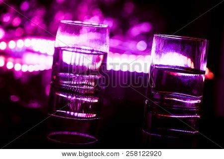 Colored Lighting Of Glasses In The Night Club Bar