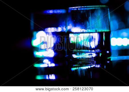 Colored Lighting Of Glasses In The Night Club Bar