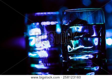 Colored Lighting Of Glasses In The Night Club Bar