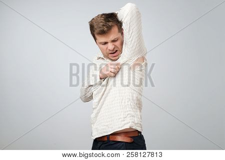 A Young Handsome Man Accidentally Tore His Shirt On His Armpit.