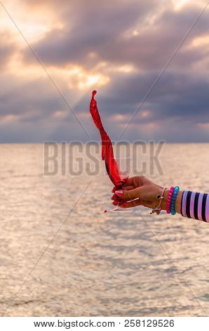 Girl Holding A Glass With Wine Uring The Sunset On The Sea