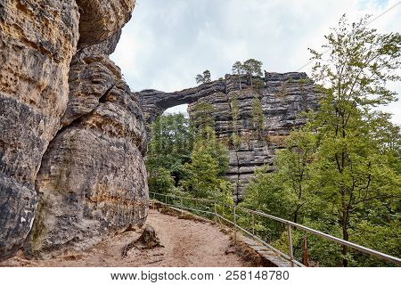 Pathway And Railing Between Beautiful Pravcicka Brana Rock Formation In Czech Republic