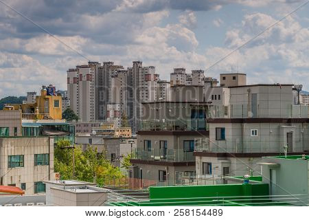 September 5, 2018; Daejeon, South Korea: Blue Sky With Puffy White Clouds Lingering Over Rooftops Of