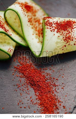 Ground Red Sumac Berries sprinkled on cucumber slice