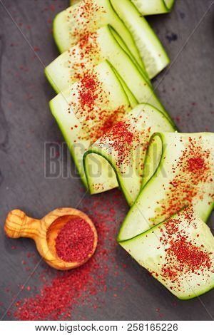 Ground Red Sumac Berries sprinkled on cucumber slice