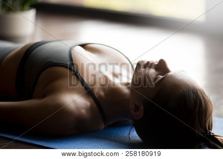 Young Sporty Attractive Woman In Dead Body Pose, Close Up