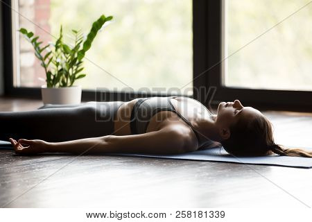 Young Sporty Woman In Dead Body Pose