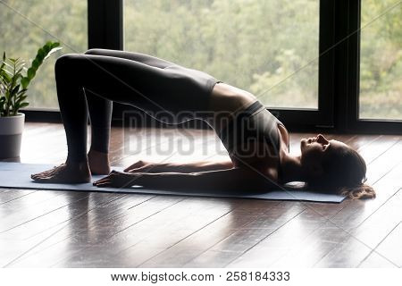 Young Sporty Woman Doing Dvi Pada Pithasana Exercise