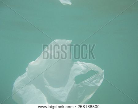 Plastic Bag Floating Into The Sea. Polluted Enviromental. Recycle Garbage