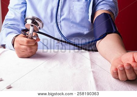 Hypertensive Patient Performing A Blood Pressure Auto Test / Man Self-monitoring Of Blood Pressure W