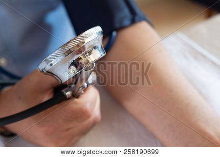 Hypertensive Patient Performing A Blood Pressure Auto Test / Man Self-monitoring Of Blood Pressure W