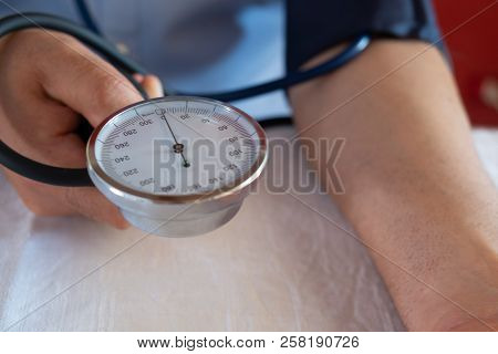 Hypertensive Patient Performing A Blood Pressure Auto Test / Man Self-monitoring Of Blood Pressure W