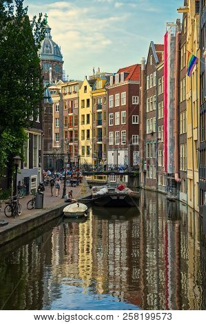 Beautiful View Of Amsterdam Canals With Bridge And Typical Dutch Houses