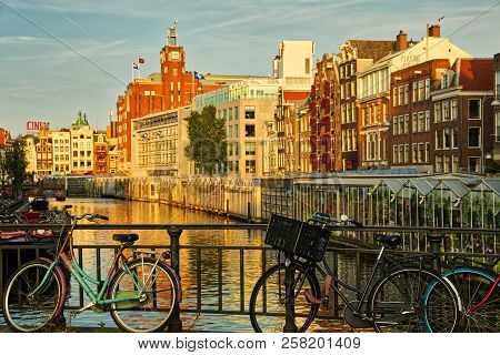 Beautiful View Of Amsterdam Canals With Bridge And Typical Dutch Houses