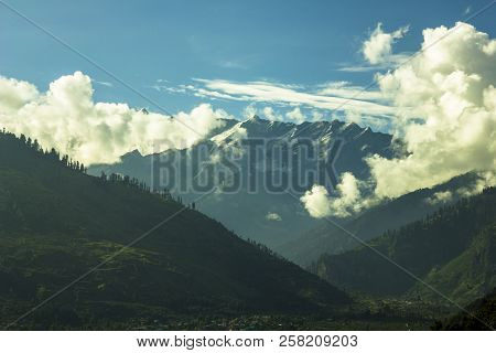 A Green Mountain Valley With Snow Peaks