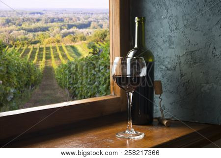 Red Wine With Barrel On Vineyard In Green Tuscany, Italy