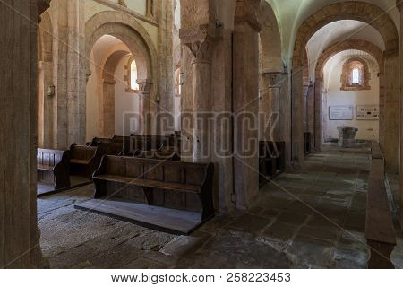 Gourdon, France - August 3, 2018: Interior With Pink Color, Wooden Benches And Huge Pilars Of The Ro
