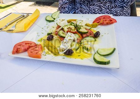 Square Plate Made Of A Greek Salad With Feta, Tomatoes, Olives, Comcombres In A Restaurant In Floren