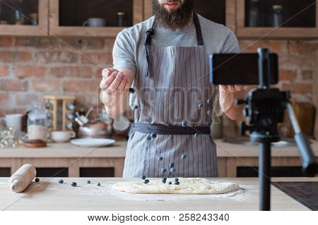 Content Creation For Social Media. Food Blogger In Apron Shooting Video Of Himself Using Camera On T