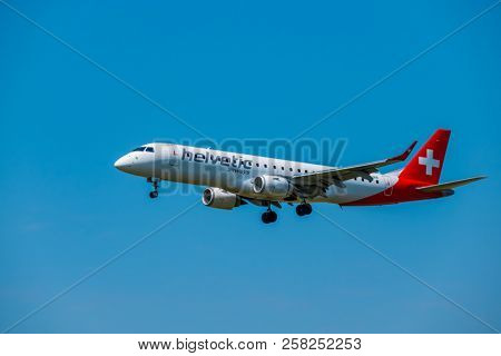 Zurich, Switzerland - July 19, 2018: Helvetic Swiss airlines airplane preparing for landing at day time in international airport