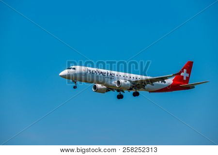 Zurich, Switzerland - July 19, 2018: Helvetic Swiss airlines airplane preparing for landing at day time in international airport