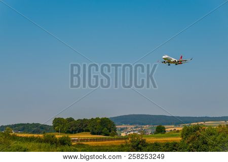 Zurich, Switzerland - July 19, 2018: Helvetic Swiss airlines airplane preparing for landing at day time in international airport