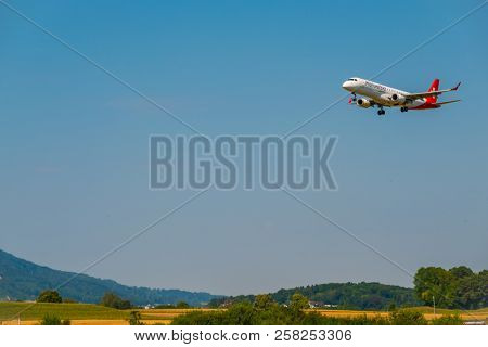 Zurich, Switzerland - July 19, 2018: Helvetic Swiss airlines airplane preparing for landing at day time in international airport