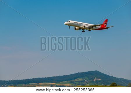 Zurich, Switzerland - July 19, 2018: Helvetic Swiss airlines airplane preparing for landing at day time in international airport