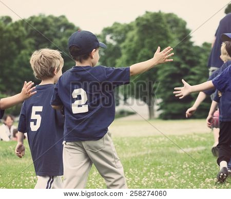 High Five line after a childs tee ball game, shallow focus