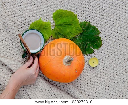 Pumpkin Spiced Coffee With Small Pumpkin The Coffee In A White Mug With Saucer And A Cinnamon Stick 