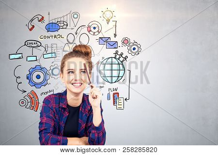 Smling Hipster Teen Girl In Checkered Shirt Sitting Near Concrete Wall With Colorful Management And 