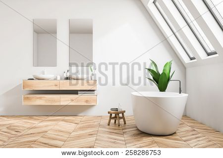 Luxury Attic Bathroom Interior In A Minimalism Style Mansion With A Wooden Floor, White Walls, A Dou