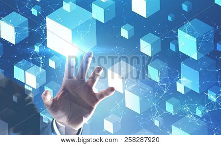 Hand Of Businessman Touching White Cubes Over Blue Background And Polygonal Network Structures Inter