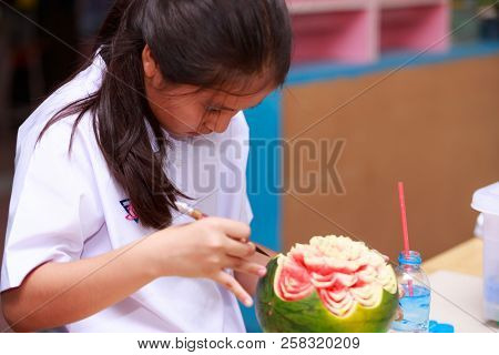 Nakhonratchasima, Thailand - August 31, 2018:asian Little Girl Carve Fruit In School