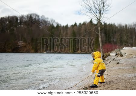 Little Boy Playing By Alpsee Lake, Located Near Hohenschwangau And Neuschwanstein Castles. Bavaria, 