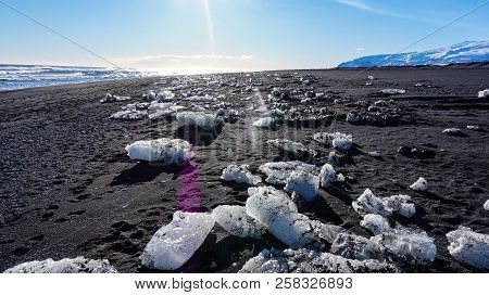 Ice On Black Beach Icebergs On A Sunny Day Near Sea