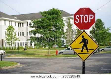 Stop Sign And Pedestrian Crossing Sign In The Residential Area