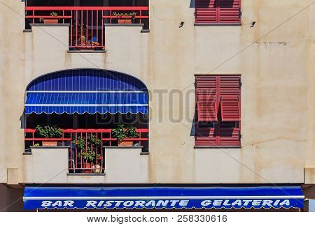 Facade Of An Old Building In Ventimiglia In Liguria Region Of Italy With A Restraurant Bar And Gelat