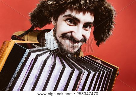 A Very Positive Man With An Accordion Posing In The Studio